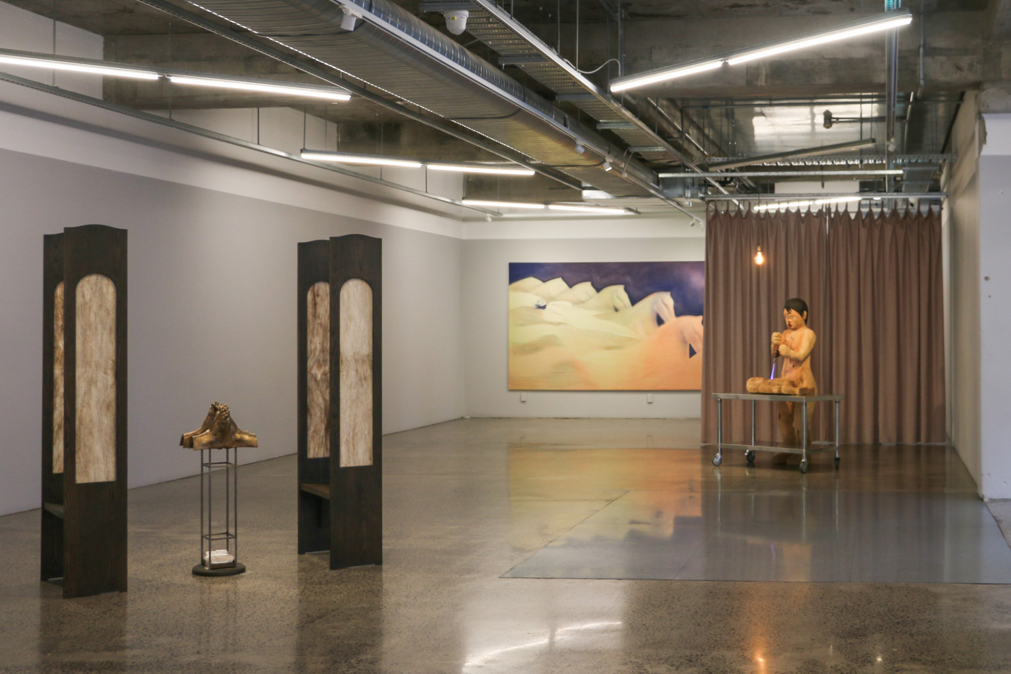 A gallery space with three art works installed.