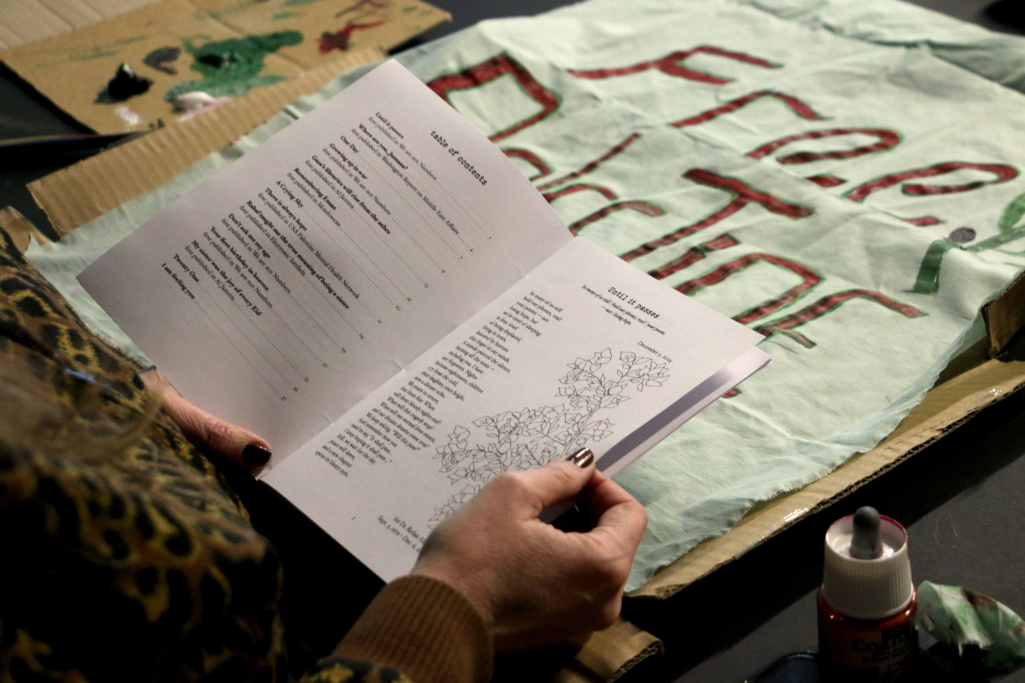 A person reading a black and white publication