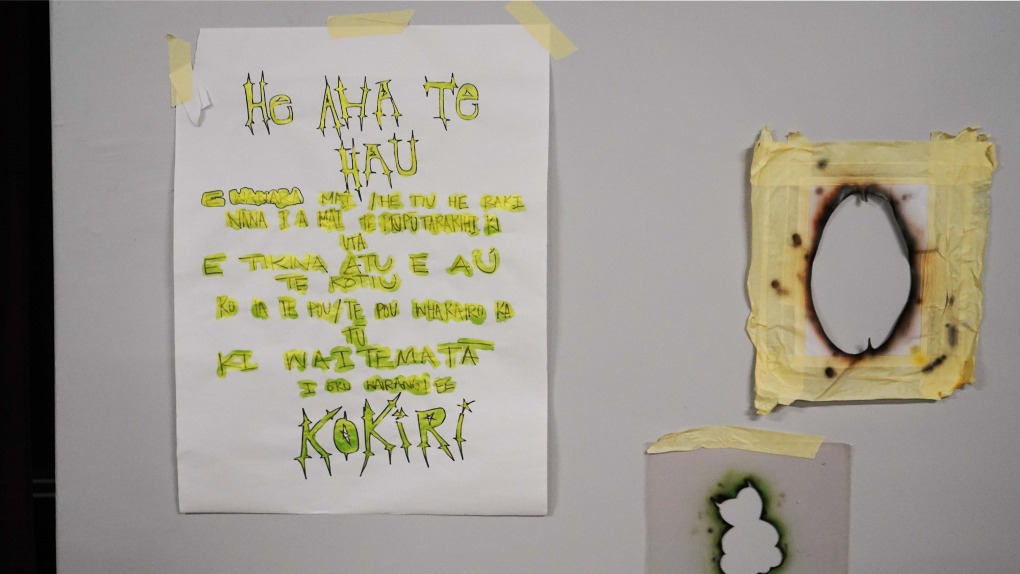 A poster written with the text, He aha te hau karakia, and stencils used for spray painting.