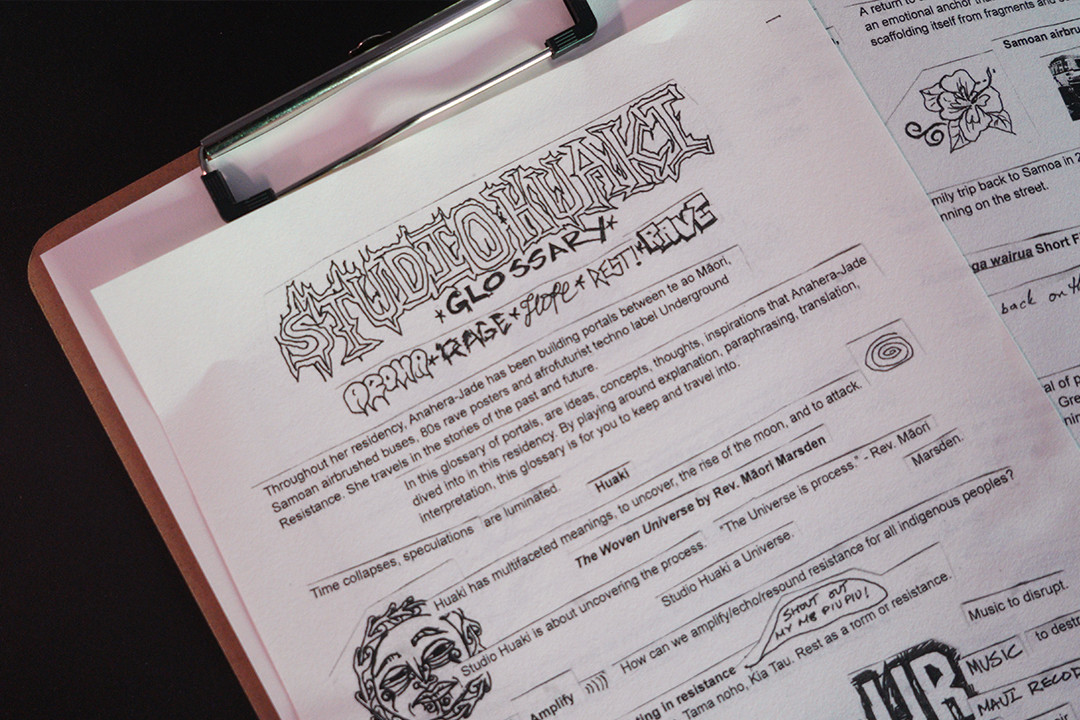 A glossary of terms from the open studio on a clip board.